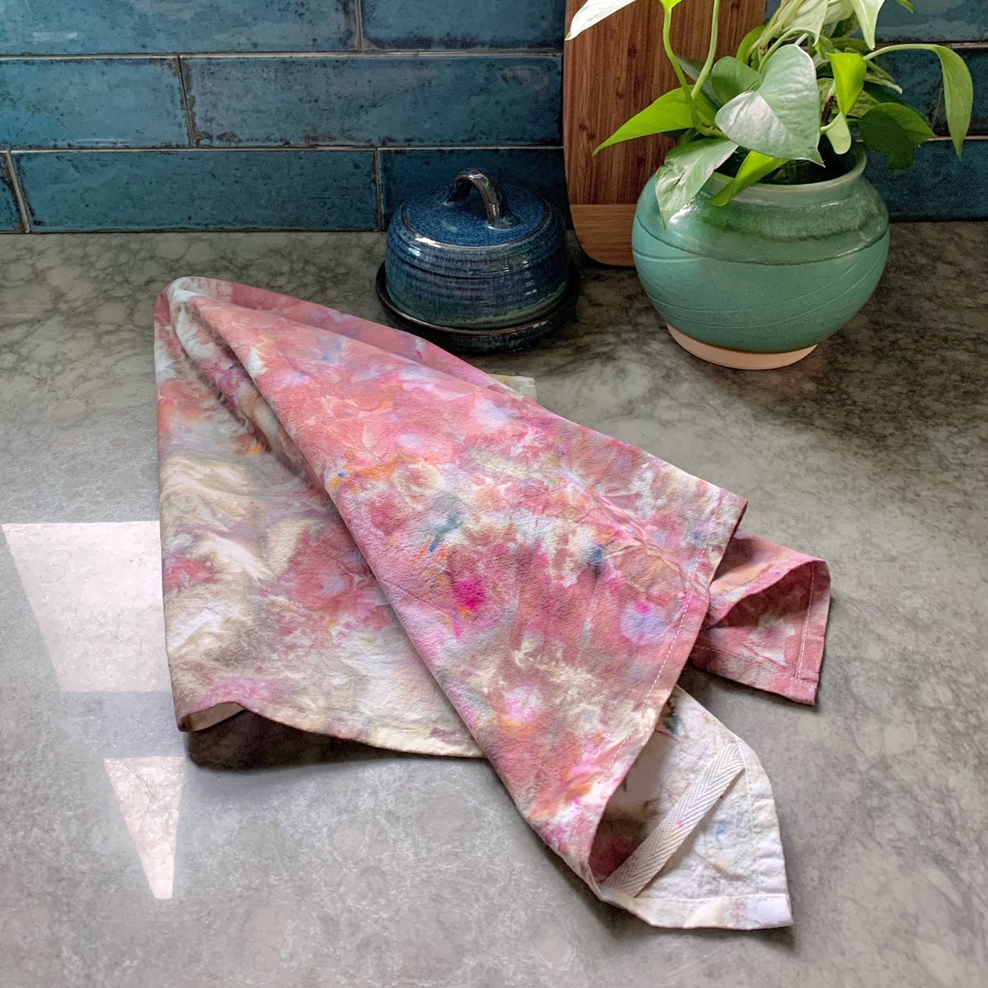 Hand-dyed purple kitchen towel shown on gray counter from Astilbe Lane